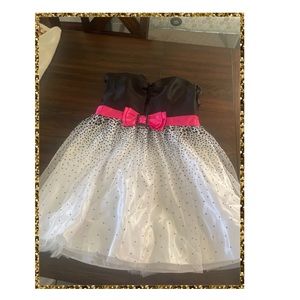 Cute polka dot dress with pink ribbon and black heart shaped design.